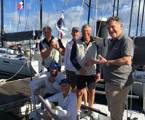 CYCA Commodore John Markos welcoming Shane Kearns and the crew of Komatsu Azzurro in Noumea
